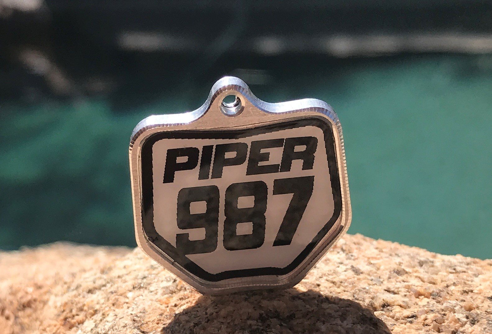 Custom Moto Mutts billet aluminum dog tag engraved with the number plate PIPER 987